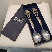 Pair of pewter salad servers with floral handles displayed in original Seagull Pewter box on white background.