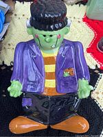 Front view of ceramic Frankenstein candy holder showing detailed paint and glossy finish.