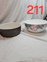 Two Villeroy & Boch serving bowls: one with vertical brown and white stripes, the other with floral design.