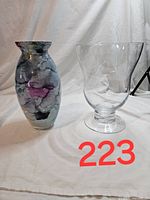 Two vases displayed side-by-side on white backdrop showing clear glass vase and watercolor print vase