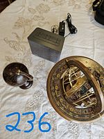 Photo showing iHome media unit alongside two globe decor items on a white tablecloth.