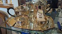 Silver plate serving set on tray showing teapot, coffee pot, creamer, and sugar bowl from above and side angle