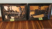 Framed copper 3D prints showing a steam locomotive train and a steamboat ship, marked with yellow note '35'