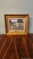 Full front view of the framed painting showing ornate gold frame and impressionistic floral artwork.