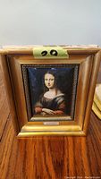 View of the framed polysmalt print of La Gioconda showing the gold wood frame and overall condition.