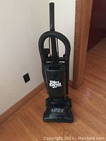 Front view of Dirt Devil Impulse upright vacuum cleaner showing brand logo and model name, along with handle and power cord.