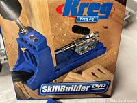 Photo of Kreg Jig SkillBuilder DVD cover showing the jig in use on wood.