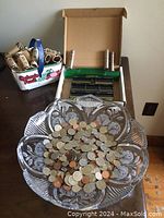 Wide view showing the clear decorative bowl filled with loose coins, the basket with coin wrappers, and the Money Master coin counter tray behind.