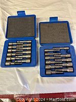 Open cases showing metric and SAE nut drivers arranged neatly in foam inserts.