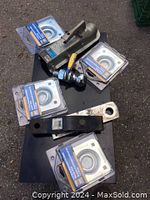 Overview of 2 inch black trailer hitch receiver with included 2 inch hitch ball and 4 packaged recessed tie-down anchor rings.