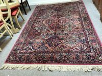 Full view of colorful wool area rug laid flat, showing overall pattern and fringe