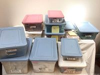 Photo showing twelve labeled plastic storage bins containing trims and ribbons.