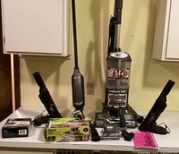 Full view of Shark upright vacuum with mop, handheld vacuum, attachments, and space bag box on countertop.