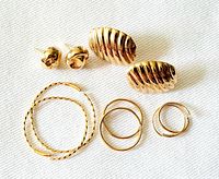 Overview of all earrings on white surface