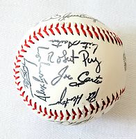 Side of baseball showing signatures including Joe Carter, Lou Piniella, and others
