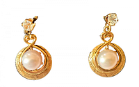 Front view of the pair of vintage 10K gold and natural pearl dangle earrings with crystal tops on white background.