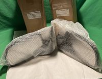 Photo of the left and right manual door mirrors wrapped in bubble wrap with the original packaging boxes behind.