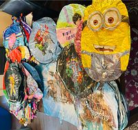 Photo showing uninflated foil balloons with Minion, Guardians of the Galaxy and other character designs in various sizes.