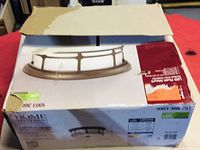 Photo of the box showing image and partial product details of the LED flush mount light fixture in oil rubbed bronze finish.