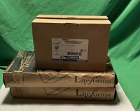 Four boxed exit signs: two Liteforms Dual Lite series and two Thomas & Betts exit signs with white and red LED labeling.