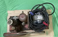 Top view of 1933 air compressor focusing on the motor, air tank, and flywheel details.