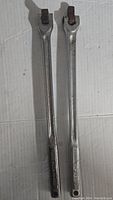 Two Craftsman long handle flex ratchets laid parallel on white surface showing entire tool length and heads.