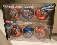 Front view of two sets of Florida Gators collegiate glass ornaments in original packaging showing six ornaments in total, three per set