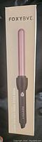 Box packaging showing FoxyBae brand and the curling wand inside box with a pink rose gold barrel.