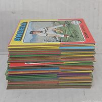 Stack of vintage baseball cards with colorful borders showing thickness and quantity of cards.