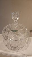 Full view of the clear crystal covered candy dish with geometric cut design and faceted knob lid.