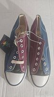 Pair of vintage 1980s Crayons tri-color Oxford shoes in men's size 8 viewed from above showing tri-color canvas panels navy blue, burgundy, and black, with white rubber toe caps and stitching. Original Crayons tags attached.