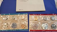 Both 1968 US proof sets in original sealed packaging with blue and red border, accompanied by white certification envelope.