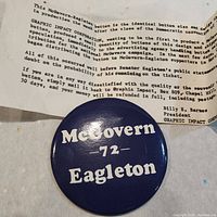 Close-up of the McGovern-Eagleton 1972 presidential election pinback button showing white text on blue background.