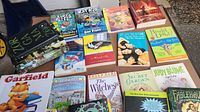 Photo of the full lot of children's chapter books including French language editions and well-known series like Percy Jackson, Roald Dahl, Judy Blume, Garfield, Cat Kid, Dog Man, and others.