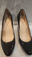 Pair of Cole Haan women's black patent leather shoes, pointed toe, size 6.5, shown from the top.