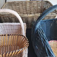 Six decorative woven baskets in various colors and sizes, tightly grouped to show batch.
