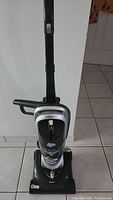 Full front view of Dirt Devil upright vacuum cleaner showing body, handle, and base.