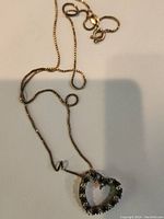 Photo of the heart-shaped pendant on a sterling silver box chain with clasp visible