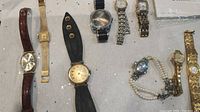 Full lot of seven ladies watches with various bands (leather, metal mesh, cuff, expandable, beaded) and different face shapes and sizes.
