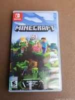 Front cover of Minecraft game case for Nintendo Switch showing pixelated game artwork and branding.