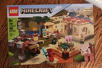 Front of LEGO Minecraft The Village Raid set showcasing box art with assembled village, characters, and farm details.