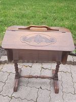 Side and front view of the vintage wooden sewing caddy on intricately turned legs with carved top detail and handle