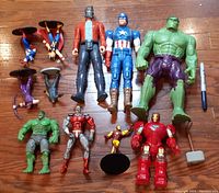 Photo showing all the Marvel action figures in the lot including large Hulk, Captain America, Star-Lord, smaller Hulk, Marvel Legends Deathlok, Galactus, electronic Iron Man, Spider-Man, Doctor Strange, and Wolverine.