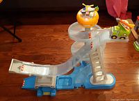 Side view of the Little Tikes Big Adventures Action Fliers Play Set showing the ramp, helicopter on orange landing pad tower, and truck on top ramp section