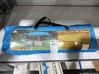 Blue Ozark Trail outdoor canopy packed inside a carrying bag with product label showing details.