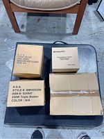 Four boxed kitchen items: 250W triple beater, immersion hand blender, Bravetti food processor accessories, and baking sheets.