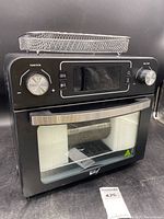 Front view of the Deco Chef toaster oven air fryer showing digital display with two control knobs and air fryer basket on top.