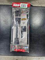 Front of the sealed Kwikset front door lock set in original packaging showing handle and lock details.