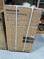 Front view of sealed cardboard box labeled Honeywell 115 Can Beverage Cooler with strapping