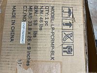Photo of cardboard box top showing model and weight information.